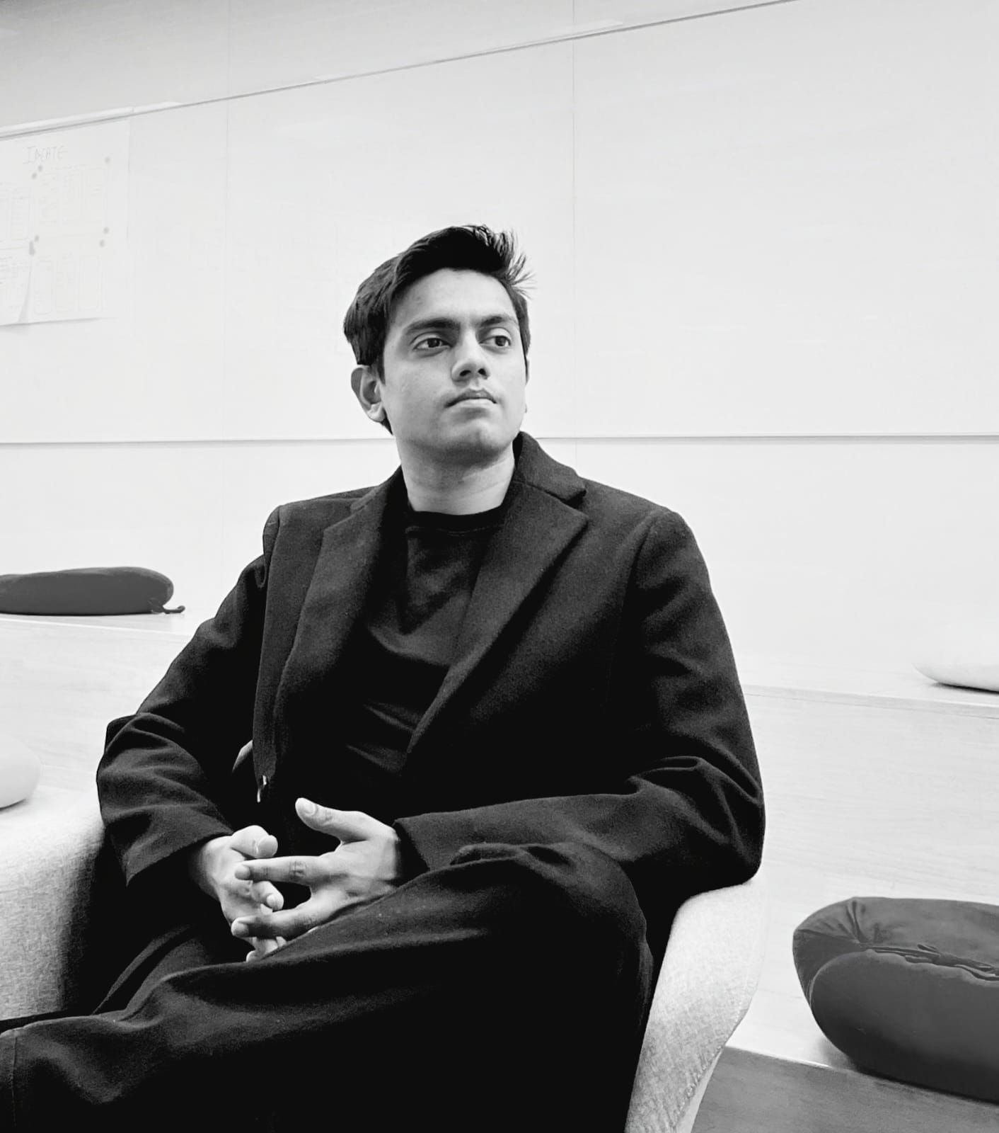 Stylized blue duotone portrait of a person facing the camera with arms crossed